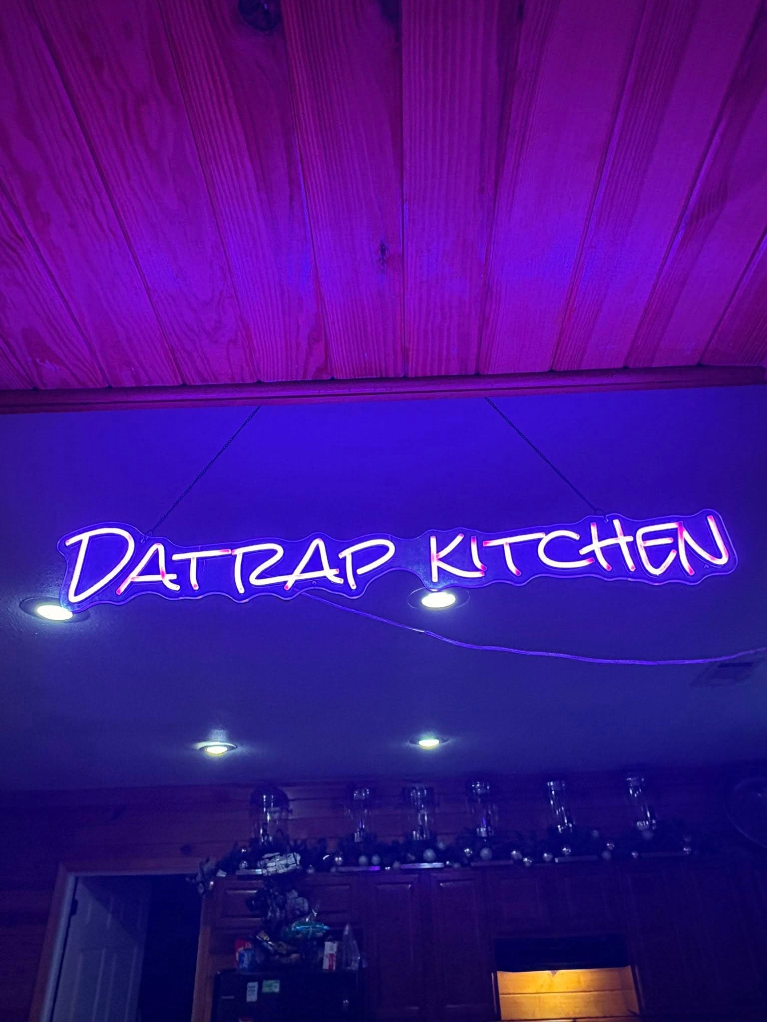 A slightly blurred, vibrant photo of the kitchen where food is prepared, conveying a sense of energy and authenticity.